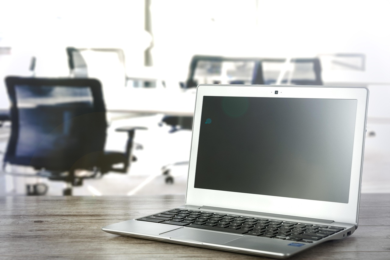 A laptop open on a desk in a quiet office